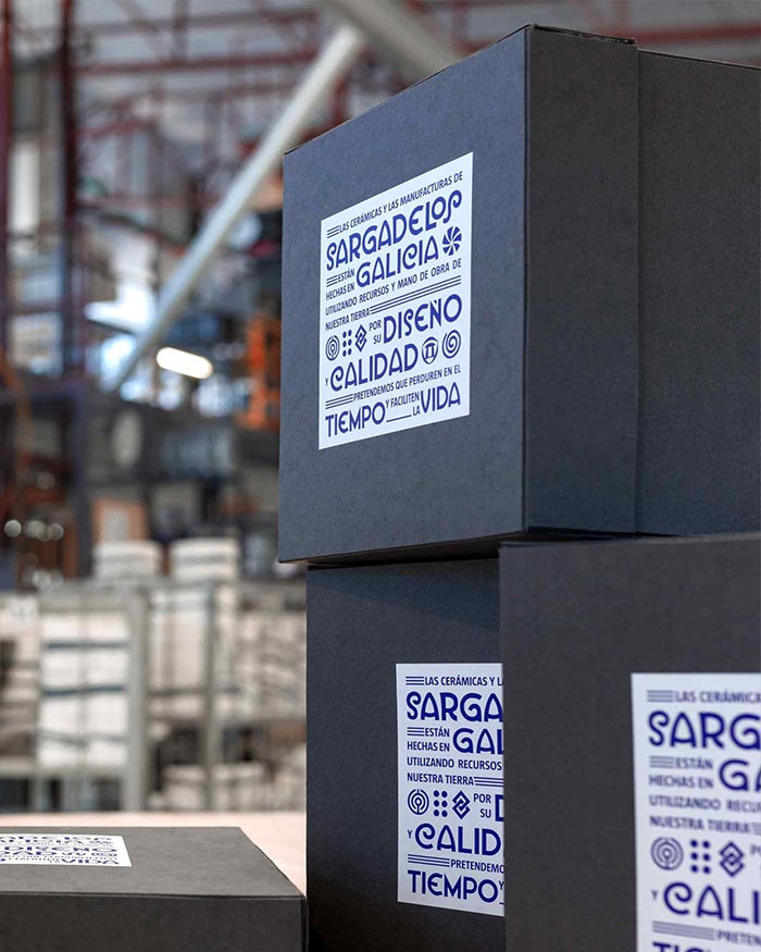 Black boxes with blue text labels in a warehouse setting